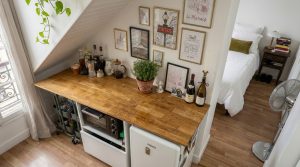 attic kitchenette ideas featuring wooden counters and mini fridge under stairs