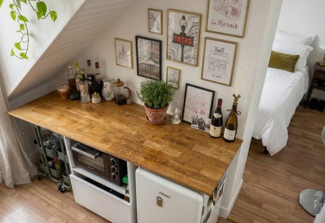 attic kitchenette ideas featuring wooden counters and mini fridge under stairs