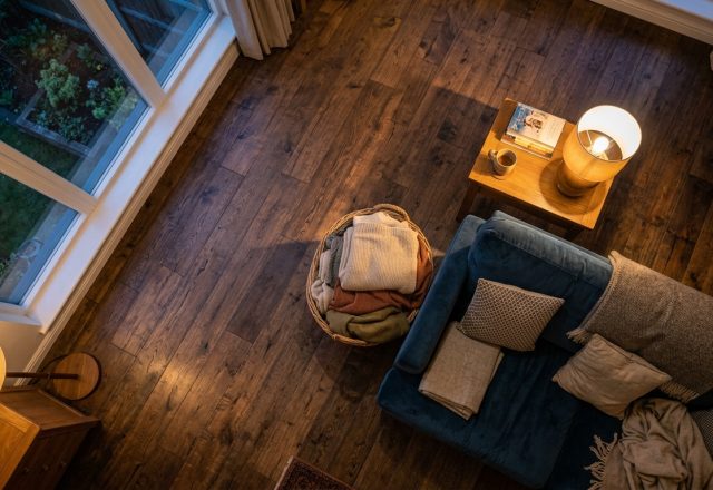 Overhead view of a cozy living room featuring dark wood flooring ideas and warm ambient lighting.