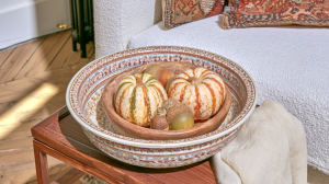 fall table centerpieces featuring mini pumpkins in nested decorative bowls on a wooden table