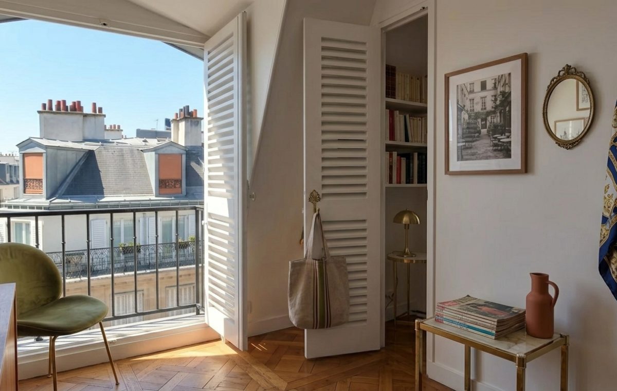 French apartment balcony decor featuring herringbone floors and wrought-iron railing