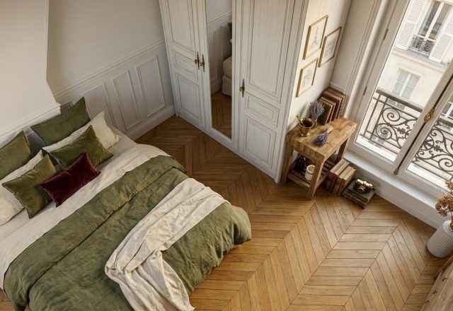 Overhead view of a French Country bedroom with herringbone wood floors, green linen bedding, and tall windows.