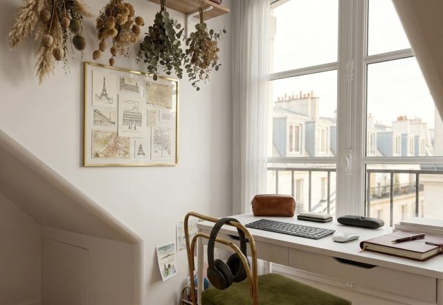 A clean small home office setup featuring a white desk, window view, and minimalist decor.
