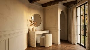 A sophisticated vanity table setup featuring a curved marble desk, boucle stool, and round brass mirror in a neutral room.
