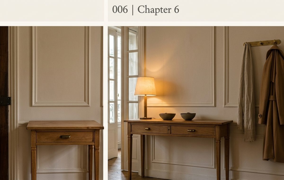 A rustic wooden entryway console table styled with a lamp and bowls against classic wall paneling.
