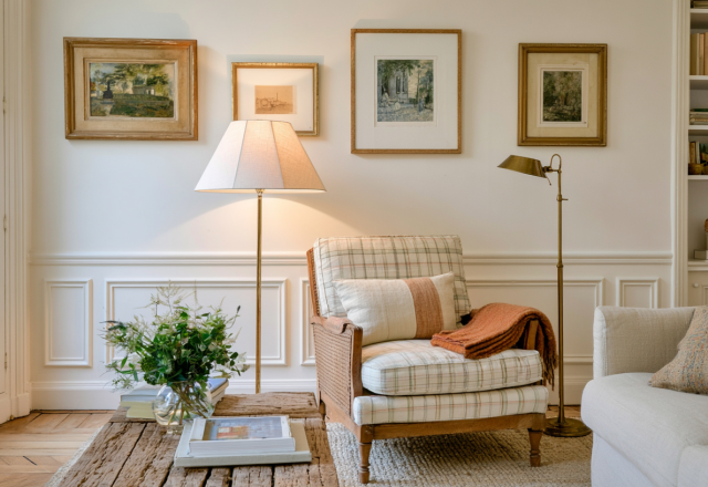 Elegant living room wall molding with vintage gallery wall and patterned armchair