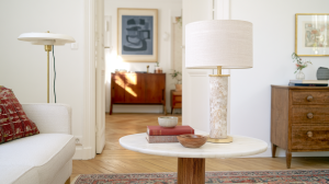 Midcentury modern living room with a marble table lamp and wooden accents