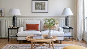 Bright transitional neutral living room styling featuring a white boucle sofa, rust lumbar pillow, and matching statement lamps.