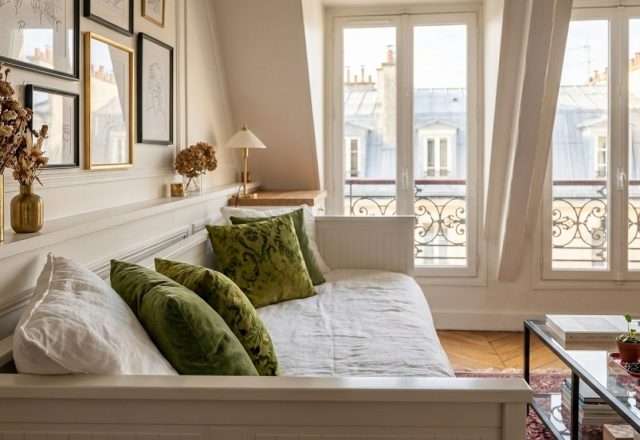Cozy living room corner featuring a white daybed styled with olive green velvet cushions and natural linen pillows.