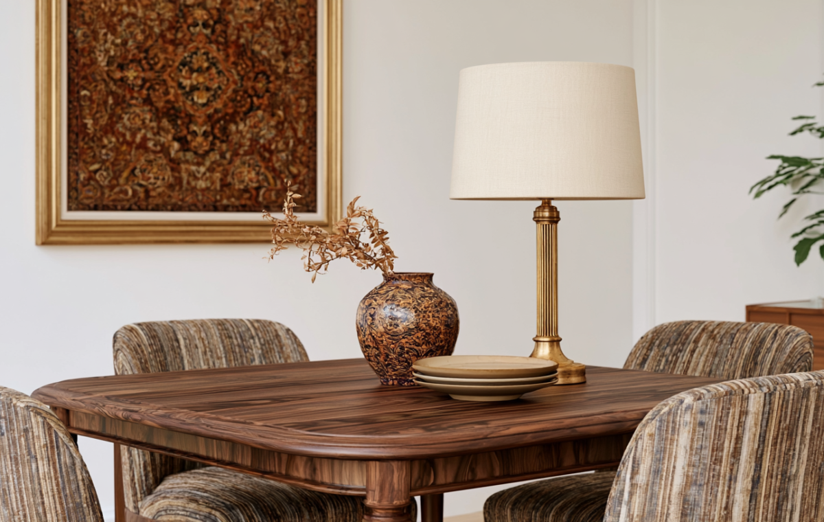Midcentury modern dining room table styling featuring a brass lamp and textured ceramic vase.