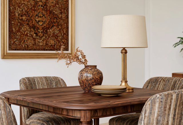 Midcentury modern dining room table styling featuring a brass lamp and textured ceramic vase.