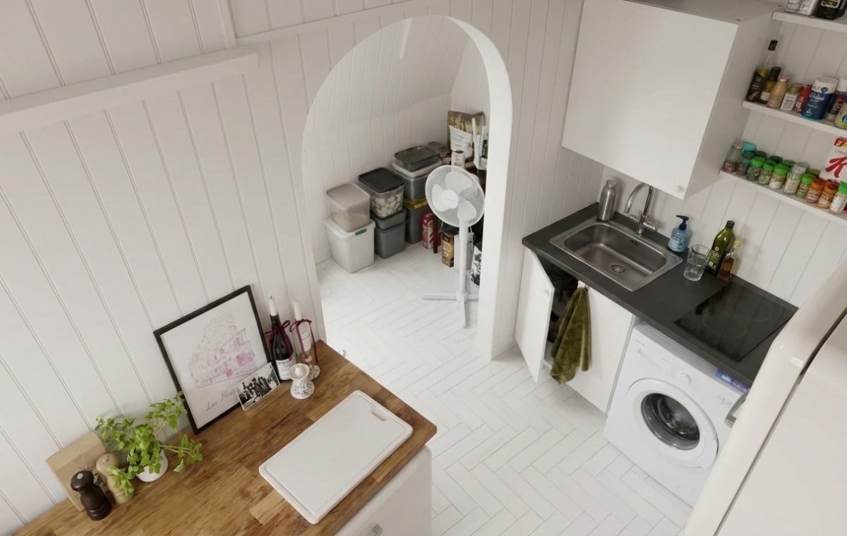 Bright small kitchen layout featuring vertical wall paneling and an under-stair pantry.