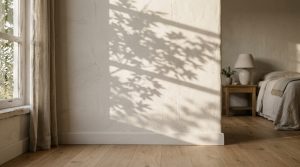 Textured minimalist bedroom wall with natural tree shadow play and wooden flooring