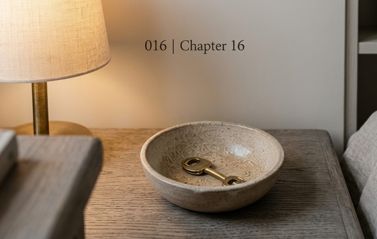 Minimalist nightstand drop bowl holding a brass key next to a bedside lamp