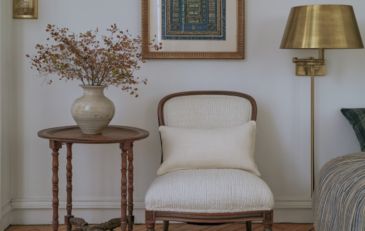 Vintage accent chair styling with wooden side table and brass wall lamp