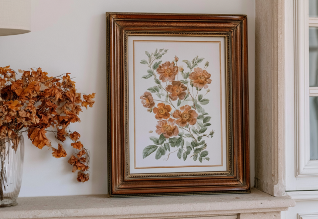 Vintage botanical print in a dark wood frame styled on a stone mantel decor setup with dried foliage