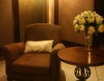 Amazing Lebua at State Tower Hotel and Club Interior Design and Facilities: comfortable contemporay sitting area with brown single soffa and round wooden table and amazing candle light holder