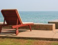 Beautiful Sunbathing Area Decoration in the Backyard with the Best Furniture: interesting-orange-wooden-sunbathing-chair-facing-the-blue-sea