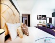 Comfortable Auris Metro Central Hotel Apartments and The Wonderful Purple Interior Designs: luxury deluxe bedroom with cream big headbed and modern bedding for Director Suite in auris metro hotel