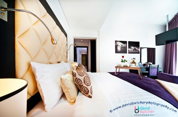: Luxury Deluxe Bedroom With Cream Big Headbed And Modern Bedding For Director Suite In Auris Metro Hotel