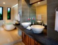 Exotic Khayangan Dreams Villa Seminyak Bali Indonesia with Tropical Nuance: luxury art deco bathroom ideas with big white bathtub and elegant white sink decorated with the brick stone wall texture