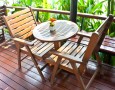 Modern Dining Room Design with Mango Wood Dining Chairs and Glass Top Designs: artistic lumber dining room table centerpieces ideas with cute artificial flowers