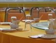Modern Dining Room Design with Mango Wood Dining Chairs and Glass Top Designs: dining table decoration ideas with yellow tablecloth and cutlery arrangement