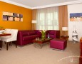 Stylish Auris Plaza Hotel with The Modern Interior Design Gallery: Minilamist living room cum diningroom with purple soffa and wooden dining table