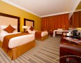 Stylish Auris Plaza Hotel with The Modern Interior Design Gallery: The fancy deluxe room with harmonious rug and curtain decoration