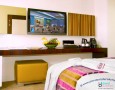 Stylish Auris Plaza Hotel with The Modern Interior Design Gallery: minimalist long multifunction table design and the wall decoration in deluxe room of Auris Plaza Hotel