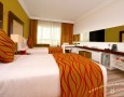Stylish Auris Plaza Hotel with The Modern Interior Design Gallery: modern deluxe bedroom with best bedding idea and long minimalist long table